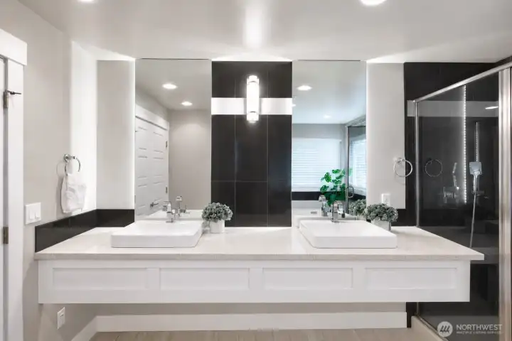 Luxury primary bath with dual vanities and modern finishes. Luxury primary bath with dual vanities and modern finishes.