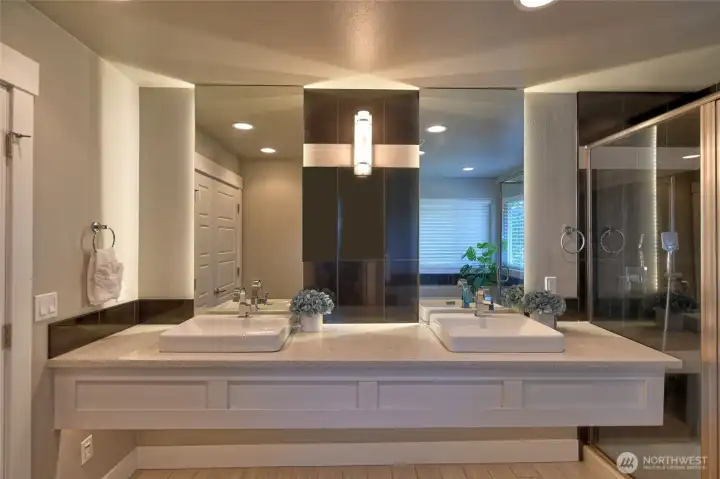 Luxury primary bath with dual vanities and modern finishes.