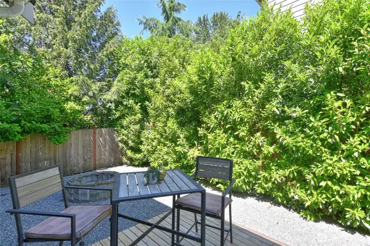 Private backyard patio surrounded by mature landscaping.