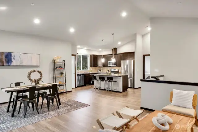 The open floor plan with vaulted ceilings creates a spacious atmosphere in the main living area on the upper level.