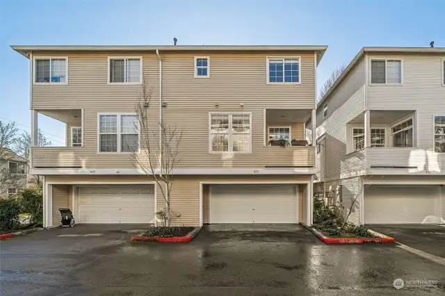 Unit on the right is the one listed. Garage and room for additional parking for a small car in front of the garage.