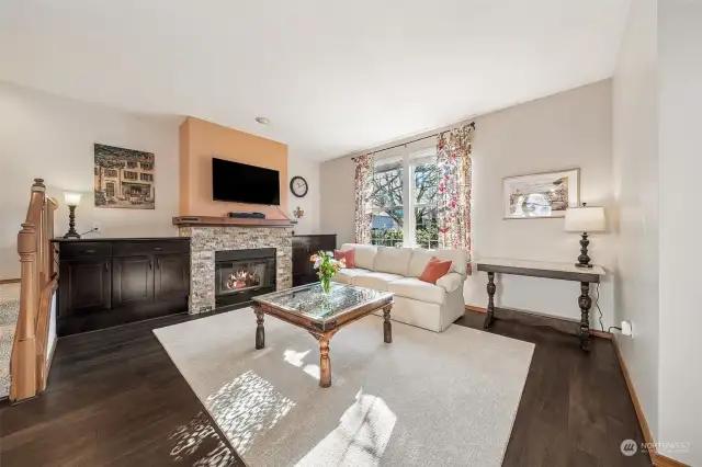 Enter to the living room with built in cabinets and upgraded mantle surrounding the gas fireplace.