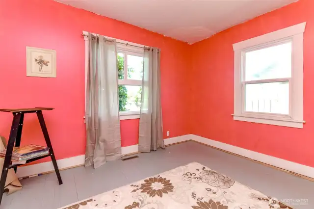 Hardwood floors recently cleaned and painted, this bedroom has a large closet and two windows.