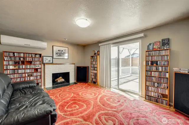 Living Room with Mini Split AC and Sliding Glass Door Leading to covered Patio