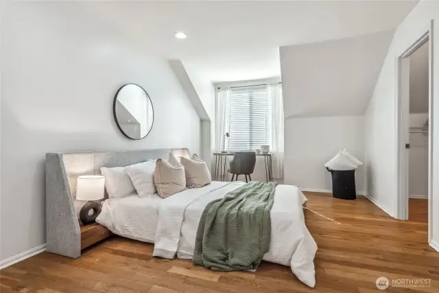 Another view of the primary bedroom with a walk-in closet.