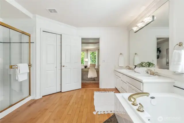 The primary bath boasts a dual sink vanity, soaking tub, and separate shower.