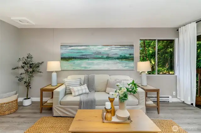 Enjoy the large living room w/ slider to the deck (right).