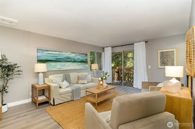 Enjoy the large living room w/ slider to the deck (right).