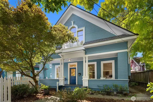 Thoughtfully positioned off the street, this freshly painted home offers a full length, shaded front porch for exceptional outdoor living. Shared driveway to off-street parking to the left/south.