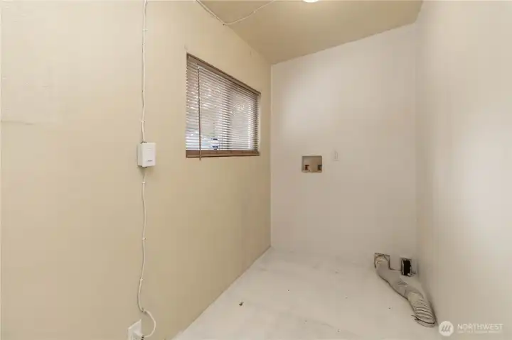 Laundry room adjacent to livingroom.