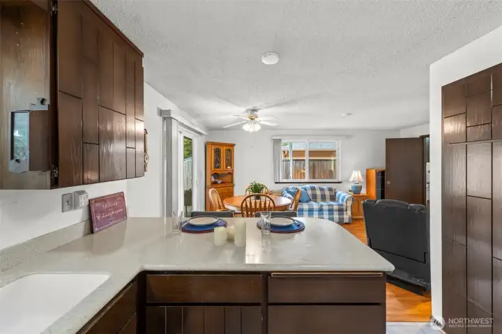 The breakfast bar serves as perfect informal dining and there is room for a table for casual meals. The flooring is a durable manufactured wood-style.