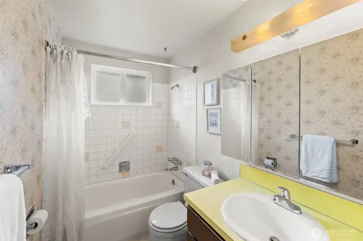 The main bath in the hall between the two secondary bedrooms features a tub/shower combo . . . the perfect space to personalize to your own taste!