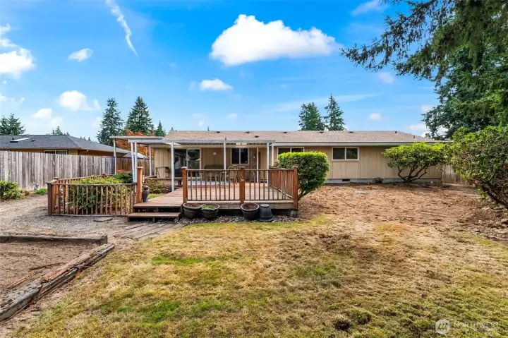 Large, fully fenced backyard with garden space to the left.