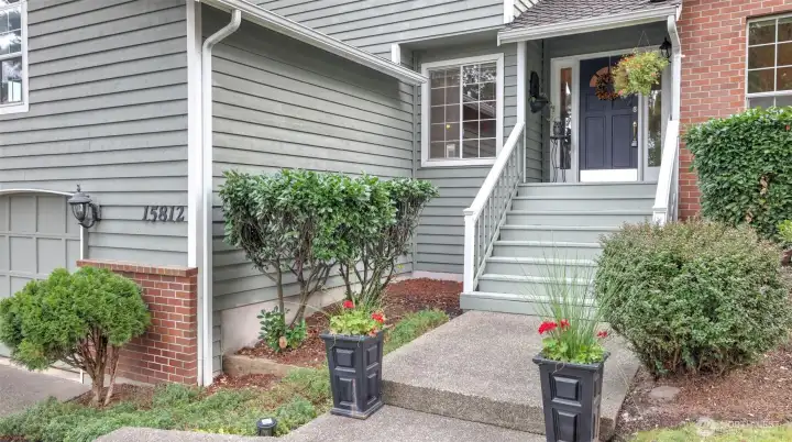 A warm welcome awaits with a charming front porch and thoughtfully designed entry.