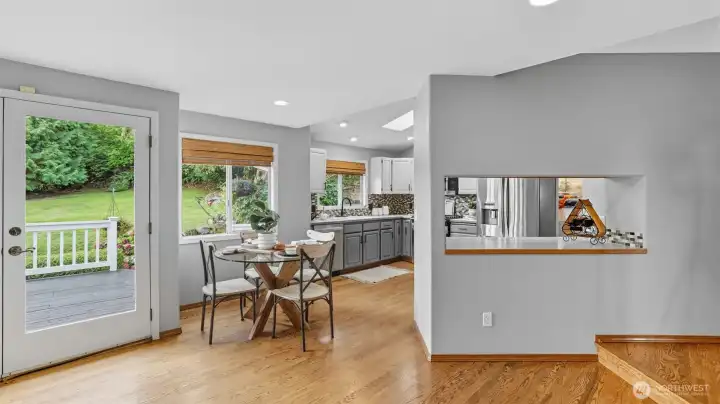 French doors open to the deck for effortless indoor-outdoor dining.
