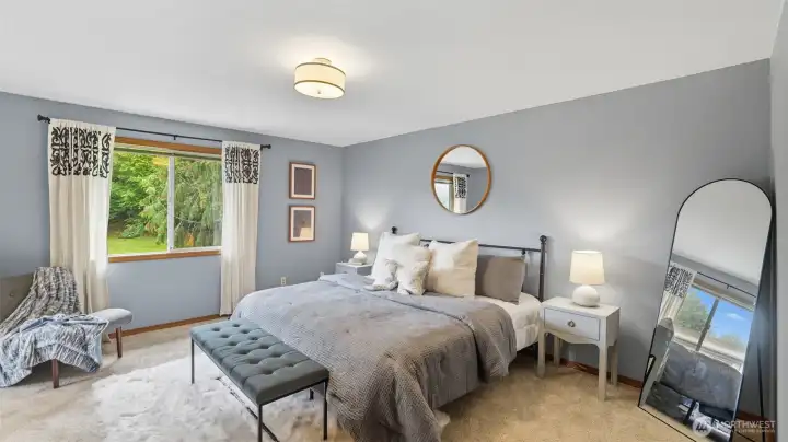 Relax and recharge in this serene primary suite with calming tones and natural light.