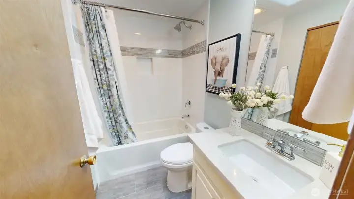 Conveniently located full bath with updated vanity and natural light.