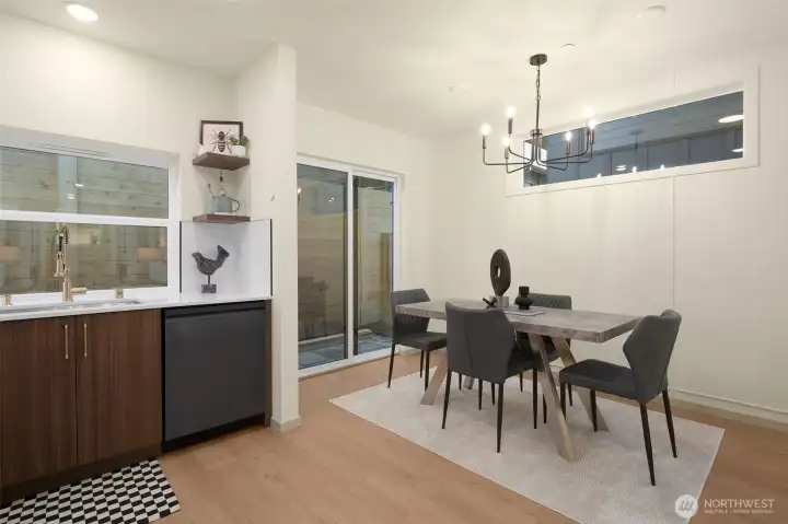 Versatile dining room area with sliding glass door access to the outdoor living space.