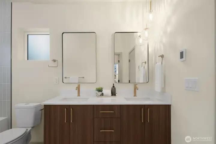 Luxurious primary bathroom boasting a double vanity and sleek contemporary finishes.