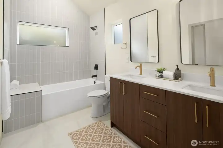 Bathroom also includes a full tub and stylish designer tile work