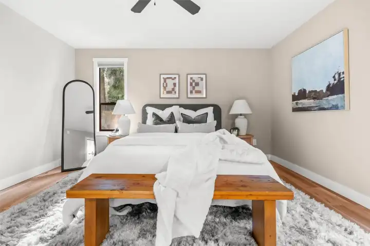 A luminous primary bedroom where sunlight floods the room, perfect for relaxing or unwinding.