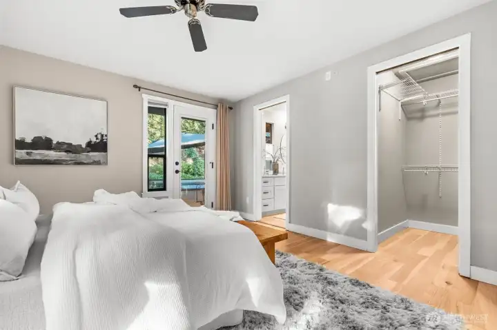 Walk-in closet, primary bathroom, and backyard access in such close proximity offers convenient living in this primary suite.