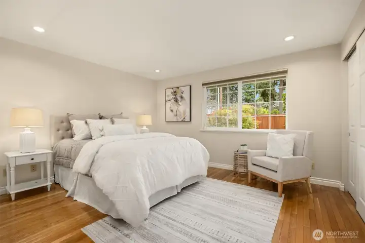 A MAIN FLOOR primary bedroom is such a rare find in a townhome. The bedroom is large and light and airy.