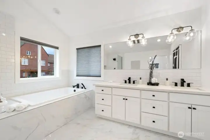 Spa-inspired primary bathroom with extra deep soaking tub and heated floors