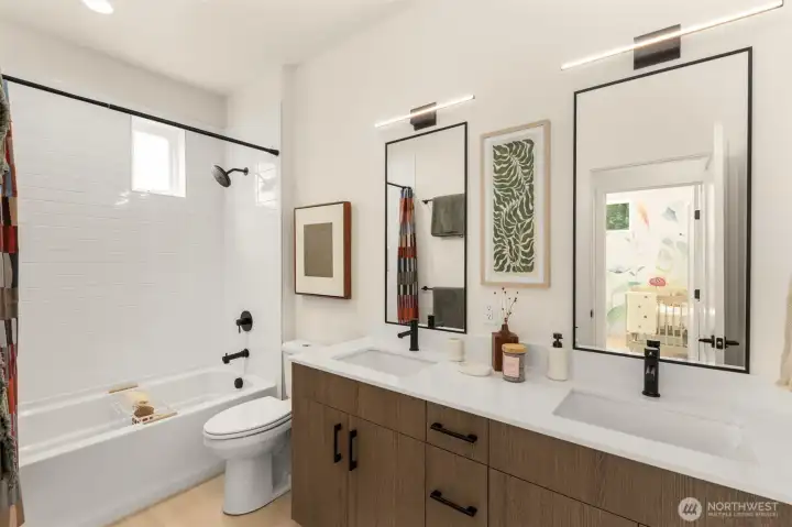 Shared bathroom. Photo is of model home of same floorplan.  Color schemes and finishes will vary per plan.