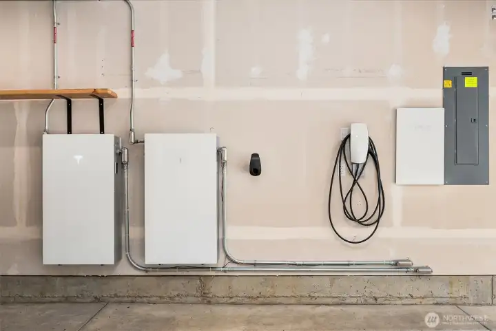 Equipped with a Tesla Level 2 EV charger and upgraded smart garage system with MyQ integration, the home is built for seamless modern living.