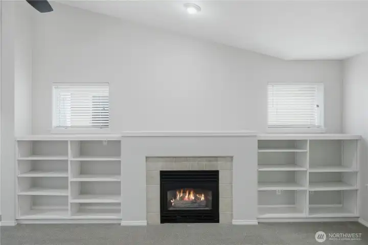 Built ins surrounding fireplace in living room