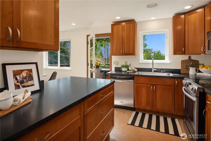 Just off the living room is this well laid out kitchen with Marmoleum floors and cherry wood cabinets.