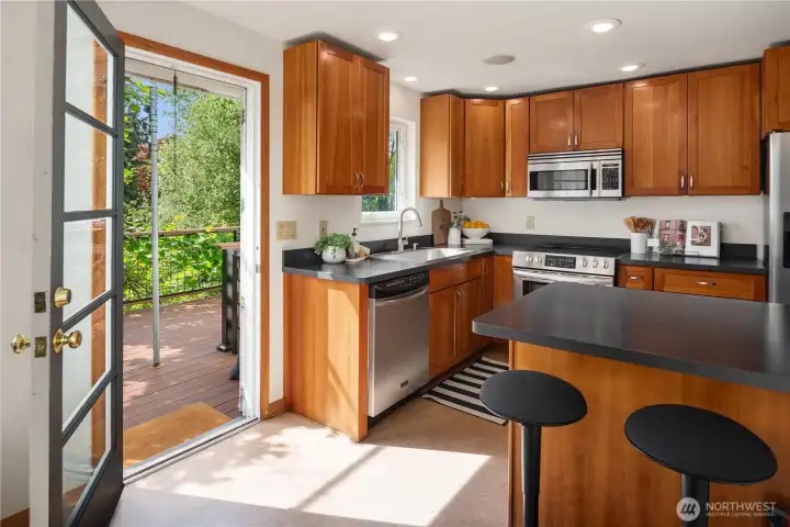 A small breakfast bar keeps the kitchen feeling open and bright.