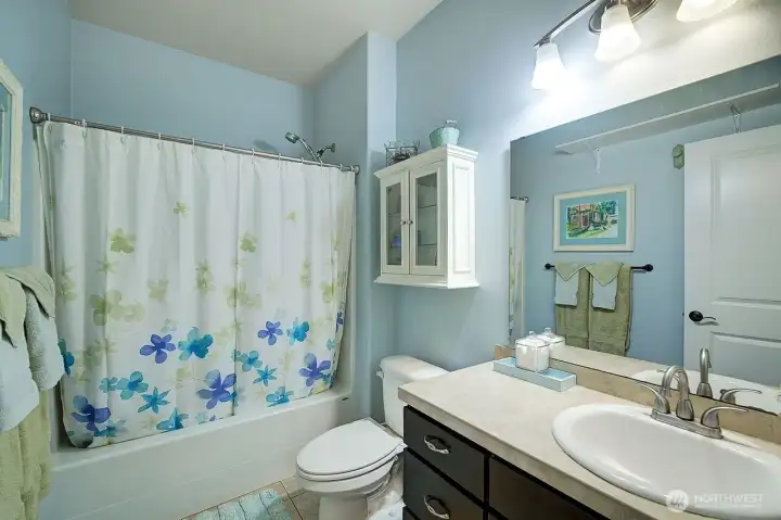 Guest bath with full shower and tub. Tile floors and counter tops. Guest bath with full shower and tub. Tile floors and counter tops.