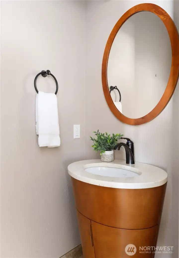 Main level half bath featuring a stunning architectural vanity that’s truly one of the coolest design features in the home Main level half bath featuring a stunning architectural vanity that’s truly one of the coolest design features in the home