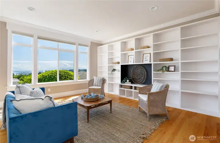 Lower level family room featuring a glass door and stunning custom wall of built-in bookshelves Lower level family room featuring a glass door and stunning custom wall of built-in bookshelves