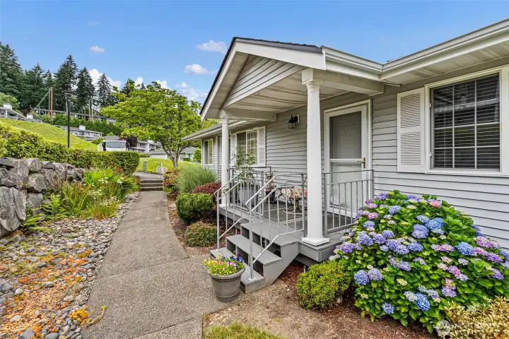 The front porch has powder coated railings and composite decking and is a lovely place to enjoy the fresh air and your favorite beverage.
