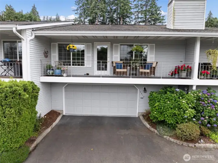 This lovely north-facing front deck provides ample space for seating, a barbecue, and potted plants. Additionally, the property features a convenient 2-car garage with easy entry and exit, offering plenty of maneuverability for vehicles.