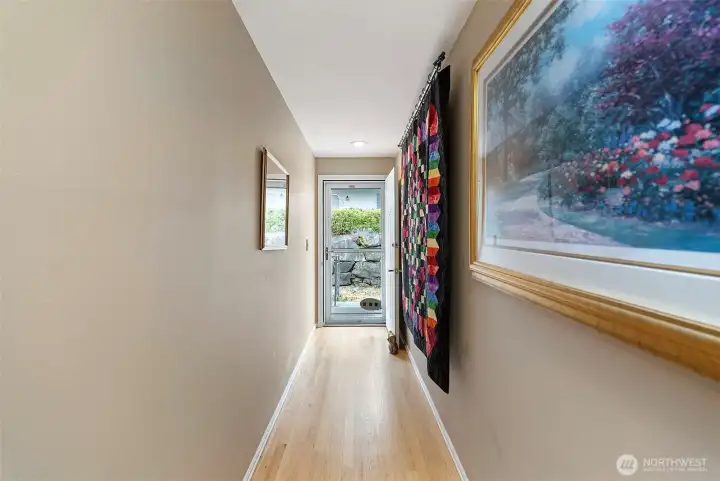 The front door features a lovely screen door that allows natural light to stream into the home, while the surrounding walls provide ample space for displaying art, family photos, quilts, or any of your favorite decor.