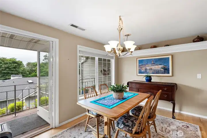 The dining room enjoys easy access to the front deck for easy entertaining, making it the perfect space for hosting dinner parties or enjoying morning coffee in the fresh air. Large windows fill the room with natural light, creating a bright and inviting atmosphere for every meal.