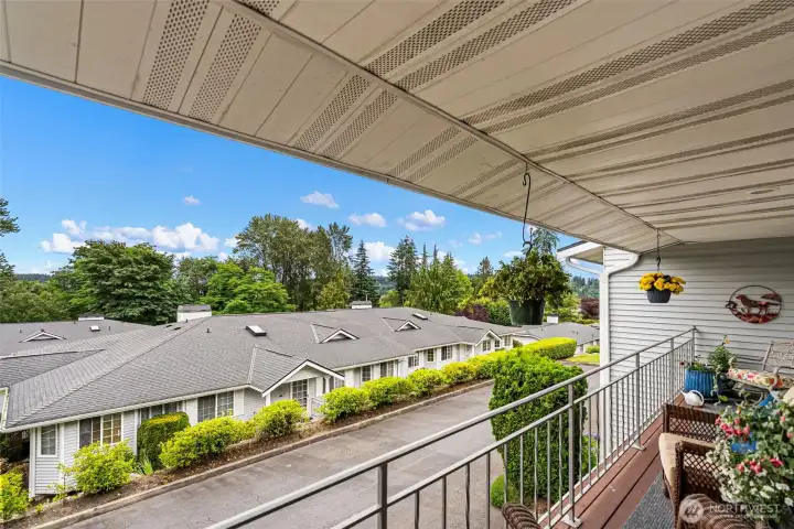 Another view from the front deck, showcasing the outdoor living space and surrounding neighborhood scenery.