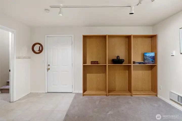Entrance to the extra-deep (on one side) 2-car garage, featuring additional space and a large dedicated storage room.