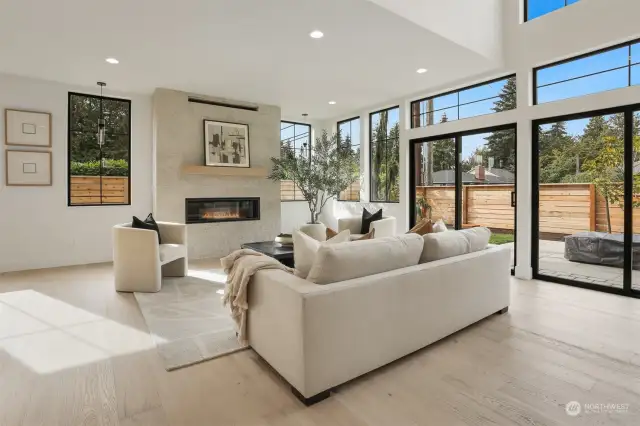 Living Room Open Ceiling to Upper Level, Double Oversized Sliders to Yard. Gas Fireplace with Floor to Ceiling Surround