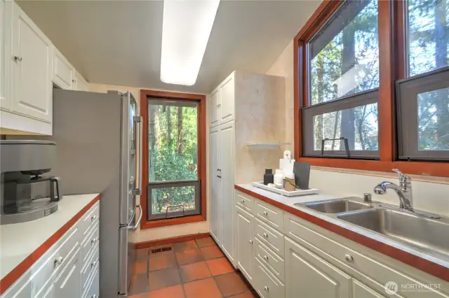 Kitchen offers an Abundance of Natual Light accented in the White Cabinetry! Virtually Staged