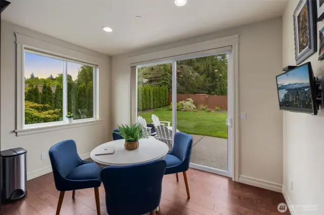 Breakfast nook with sliding glass door to patio and yard.