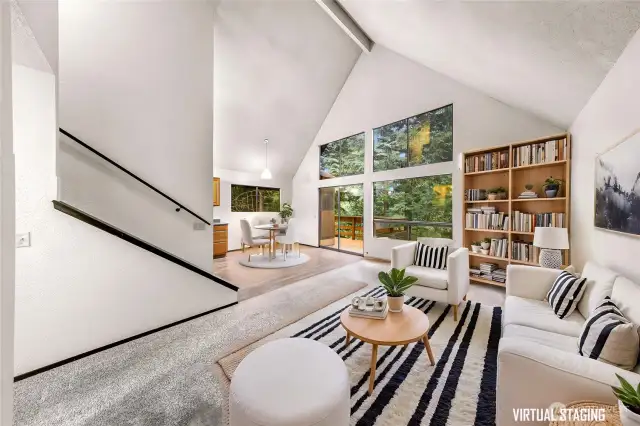 Living room with vaulted ceilings and view of trees