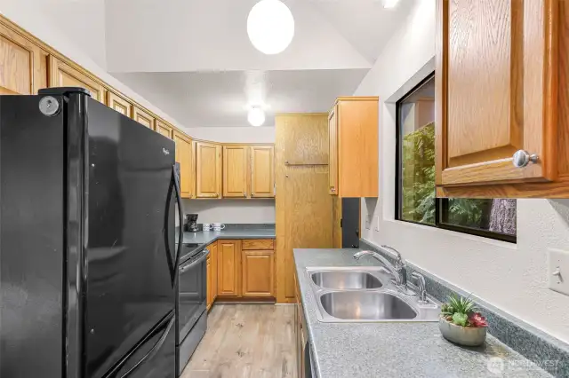 From dining area looking into kitchen. Floor to ceiling cabinet holds hot water tank