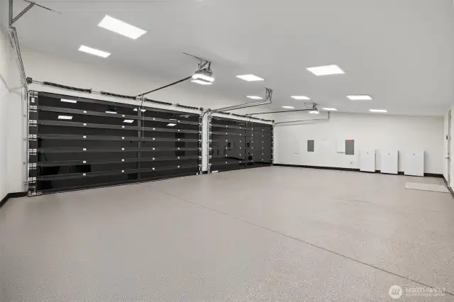 Oversized 4 car garage with heated and epoxied flooring.