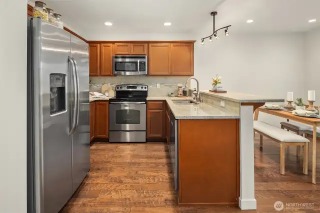 Open kitchen with eat at bar and space for dining table
