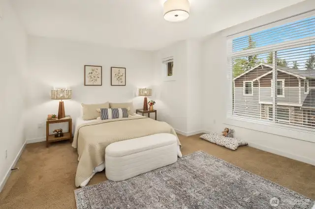 Primary bedroom is large with big windows and large walk in closet